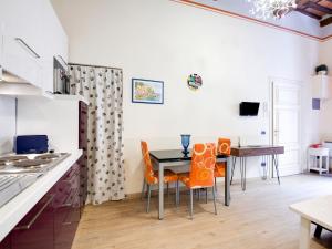 a kitchen with a dining room table and orange chairs at Mansion in Lucca near Via Fillungo in Lucca +16 photos