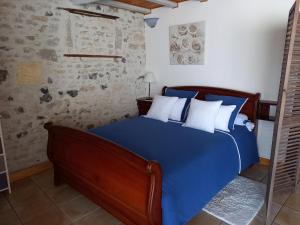 a blue bed with white pillows in a bedroom at La charentaise ch d'hôtes ,Studio in Chérac +19 photos