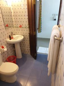 a bathroom with a toilet and a sink at Nungwi Inn Beach Cottages in Nungwi