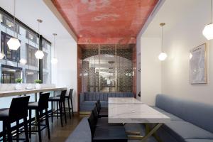 a restaurant with a table and chairs and a bar at InterContinental Montreal, an IHG Hotel in Montreal