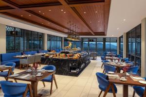 a restaurant with tables and chairs and a buffet at Storii By ITC Hotels, Amoha Retreat Dharamshala in Dharamshala