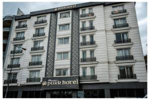 a white building with a sign for a panic hotel at ADIYAMAN PARK HOTEL in Adıyaman