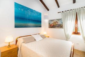 A bed or beds in a room at Villa vista Mare Santa Teresa