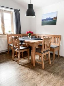 a dining room with a wooden table and chairs at Fewo Aschauer in Schönau am Königssee