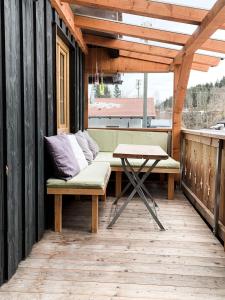 a bench and a table on a wooden deck at Fewo Aschauer in Schönau am Königssee