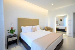 a bedroom with a large white bed in a room at Angiolina Apartments in Sorrento