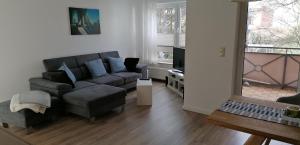 a living room with a couch and a chair at Schönes 2-Zi. App. 55 qm - voll möbliert - citynah in Elmshorn +8 photos