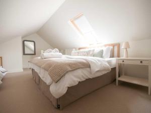 a bedroom with a large bed in a attic at No 1 The Hinges in Newquay