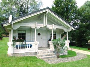 a small white house with a man standing in it at Landhaus-Pension Zum Waffenschmied in Brand +5 photos