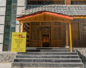 a building with stairs and a sign in front of it at Whoopers Hostel Kasol in Kasol