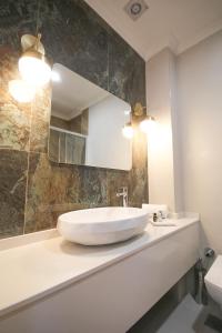 a bathroom with a sink and a mirror at KAR BEYAZ HOTEL BURSA in Bursa