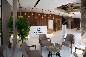 a waiting room with chairs and a table and a sign at KAR BEYAZ HOTEL BURSA in Bursa +22 photos