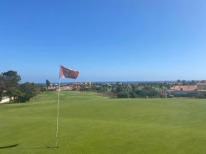 a red flag on a green golf course at Villa with private pool, near beach and golf Caleta de Fuste- Villa Charlotte in Costa de Antigua