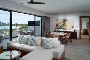 a living room filled with furniture and a large window at Dreams Macao Beach Punta Cana in Punta Cana
