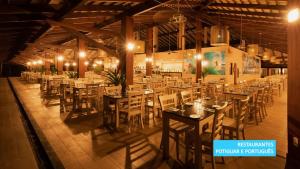 a dining room with tables and chairs in a building at Vila Galé Resort Touros - All Inclusive in Touros