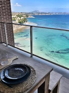 una mesa en un balcón con vistas al océano en Apartamentos Santa Clara, en Calpe
