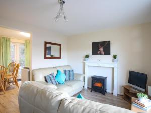 a living room with a couch and a fireplace at Eirlys in Caernarfon