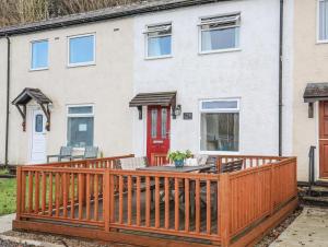 a wooden deck in front of a house at Eirlys in Caernarfon
