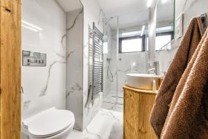 a bathroom with a toilet and a sink at Apartments Srdiecko - JASNA South, FOREST View, SAUNA in One Apt FIREPLACE in Both in Tale +34 photos