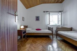 a room with two beds and a desk and a window at Beachfront Apartment Pisak (196-2) in Pisak