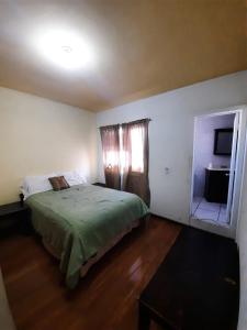 a bedroom with a bed in a room with a window at Terraza de campo in Rosarito