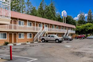 a hotel with a truck parked in a parking lot at Americas Best Value Inn - Ukiah in Ukiah