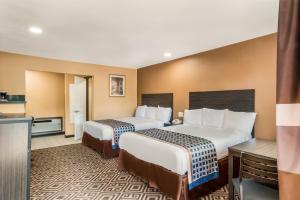 a hotel room with two beds and a kitchen at Americas Best Value Inn - Ukiah in Ukiah