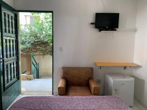 Uma TV ou centro de entretenimento em Villa Paraíso