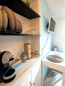 a kitchen with a shelf with dishes on it at SeaBreeze Vernazza in Vernazza