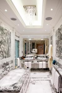 a bathroom with two sinks and a large mirror at The Langham London in London