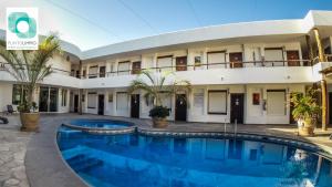 a hotel with a swimming pool in front of a building at Hotel Maioris La Paz in La Paz