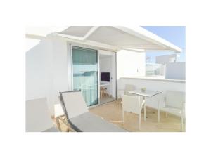 a room with a table and chairs and a dining room at SUNNY DAY Deluxe 14 in La Playa de Arguineguín