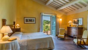 a bedroom with a bed and a door to a patio at SAN FRANCESCO 12, Emma Villas in Sarteano +35 photos