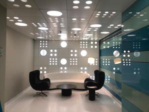 a meeting room with two chairs and a table at Cocoon Luxury Business Hotel in Dhanbād