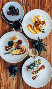 a group of plates of food on a wooden table at Temple Point Resort in Watamu