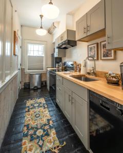 a kitchen with a sink and a counter top at The Water Street Inn in Kittery