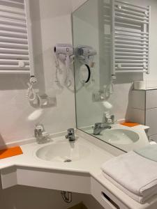 a bathroom with a sink and a mirror at Cafe Moselterrasse in Klotten