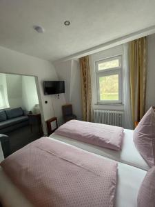 a hotel room with two beds and a window at Cafe Moselterrasse in Klotten