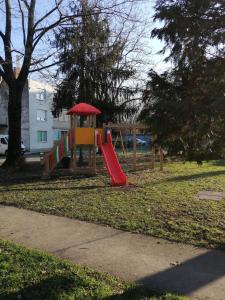 a playground with a slide in a park at Apartman Ljubica in Daruvar
