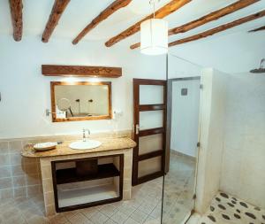 a bathroom with a sink and a mirror at Temple Point Resort in Watamu