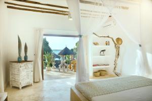 una camera da letto con un letto e vista sull'oceano di Temple Point Resort a Watamu