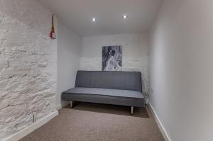a bench in a room with a painting on the wall at Alexandra Cottage Comfortable Apt near Swansea & M4 in Swansea