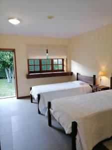 a bedroom with two beds and a window at Quinta Do Fijo in Arcos de Valdevez