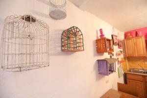 a kitchen with bird cages hanging on the wall at Majikal B&B - Frida in Cholula +6 photos