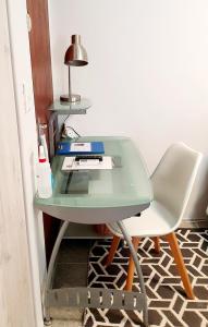 a green desk with a chair and a lamp at Mountain Rose Cottage in Bellville