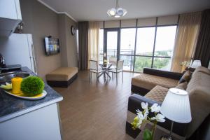 a kitchen and living room with a couch and a table at Lux Apartment in Batumi