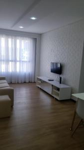 a living room with a couch and a tv in it at Flat Espinheiro Prime in Recife