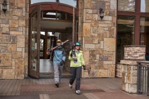 a man and a woman walking out of a building at Bear Creek Lodge in Telluride