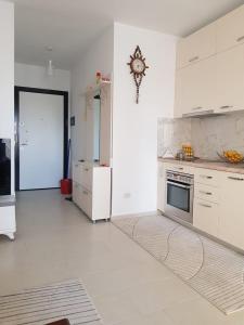 a kitchen with white cabinets and a stove at Diar Apartment in Durrës
