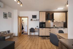 a kitchen with wooden cabinets and a dining room at Apartment Little Gallery **** in Rovinj